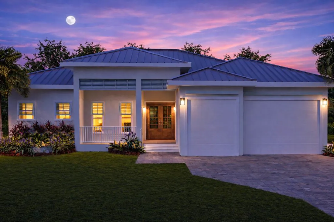 Coastal Collection at dusk - the Cape Horn home with its porch and garage lit