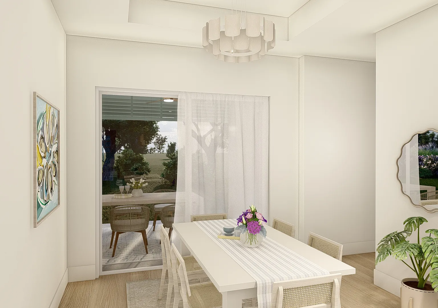The dining room in the Coastal Collection - a white table under a sculptural chandelier, with sliding doors through to the covered lanai