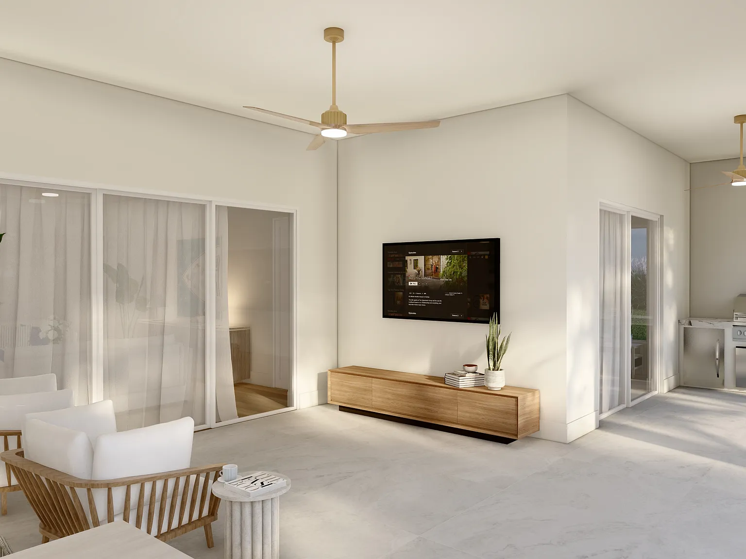 The covered lanai in the Coastal Collection - a wall-mounted television, a built-in outdoor kitchen and sliding doors back into the living space