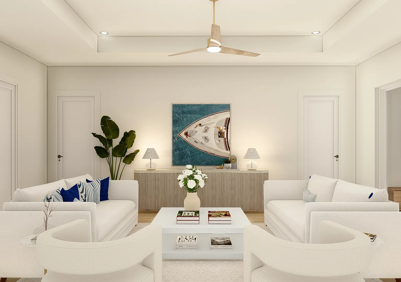 The living room in the Coastal Collection - two facing sofas, a fluted credenza and a tray ceiling with a wood-bladed fan