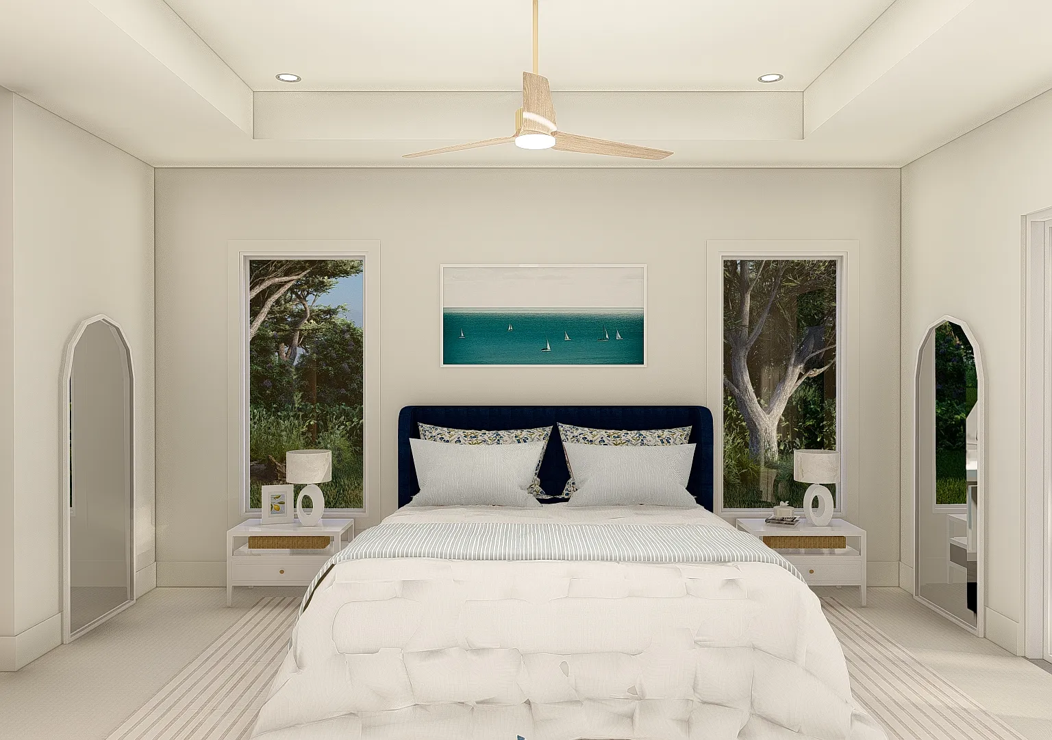 The primary bedroom in the Coastal Collection seen head-on - a navy upholstered bed between two tall windows under a tray ceiling