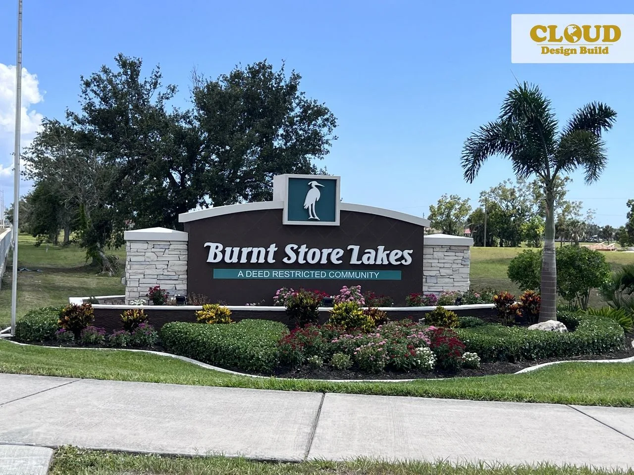 Burnt Store Lakes entrance sign with stone pillars and landscaped gardens in Punta Gorda