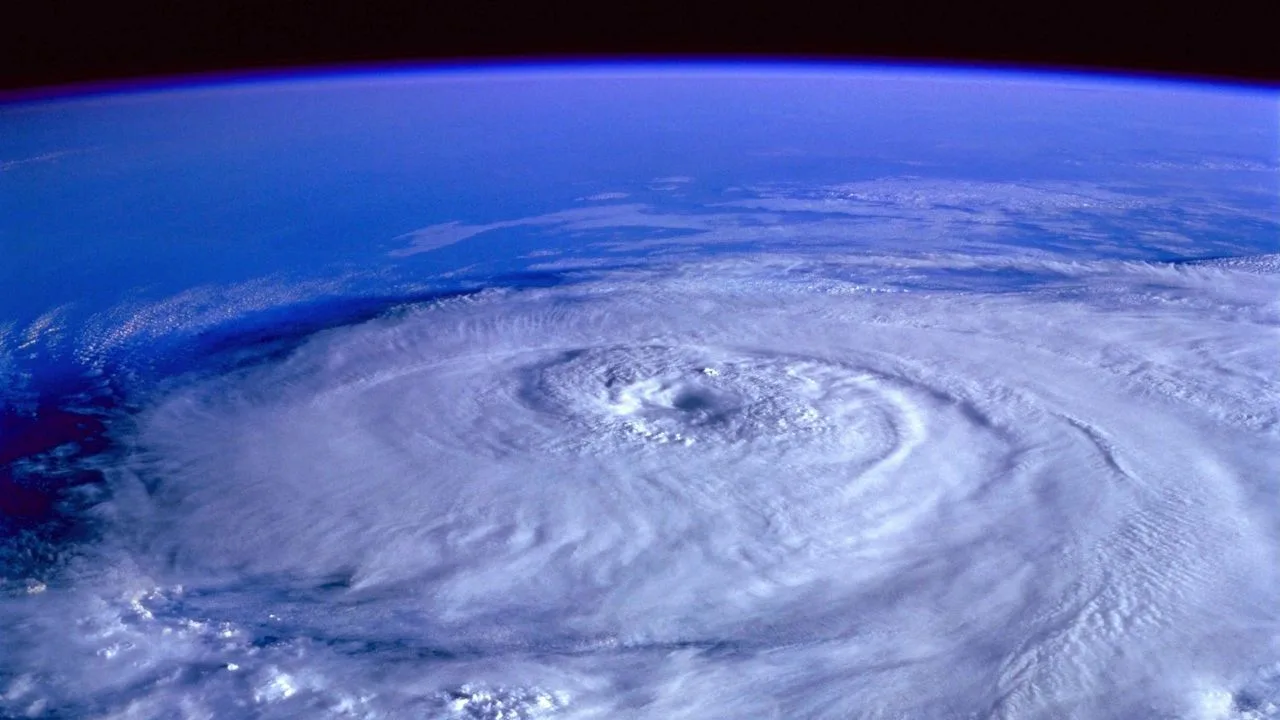 Satellite view of a hurricane’s eye and spiral cloud bands over the ocean