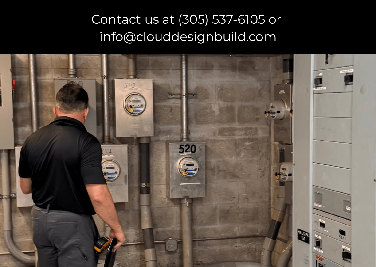 Consultant inspecting electrical meters and panels in a building’s mechanical room