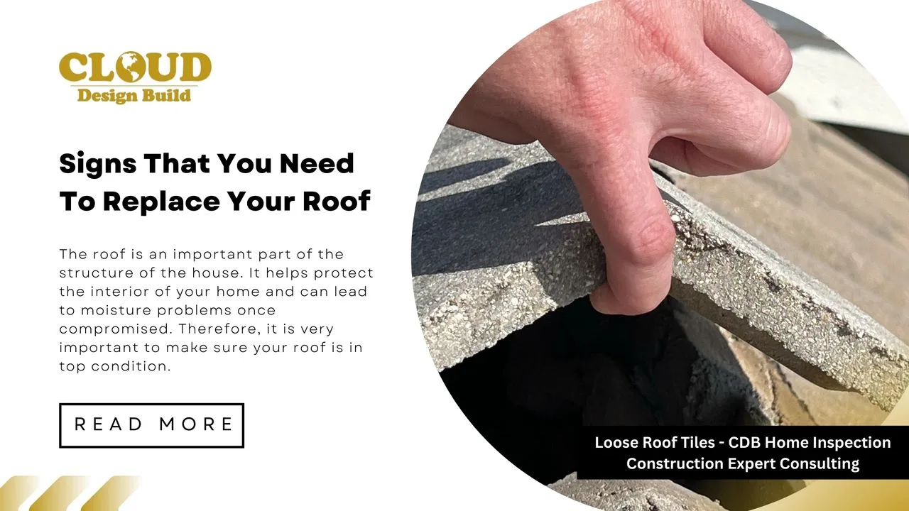 Inspector lifting a loose concrete roof tile during a Cloud Design Build home inspection