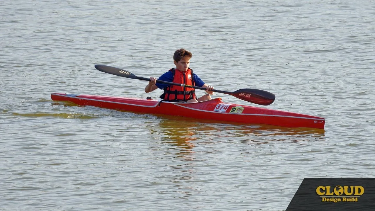 Man paddling a red kayak on one of the Burnt Store Lakes waterways