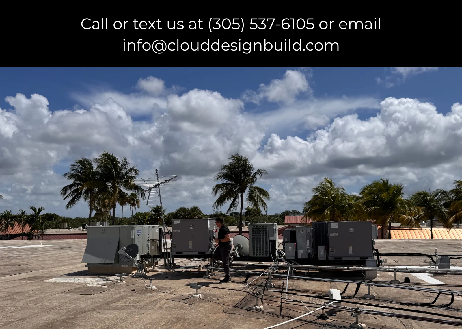Rooftop HVAC units being inspected with palm trees in the background