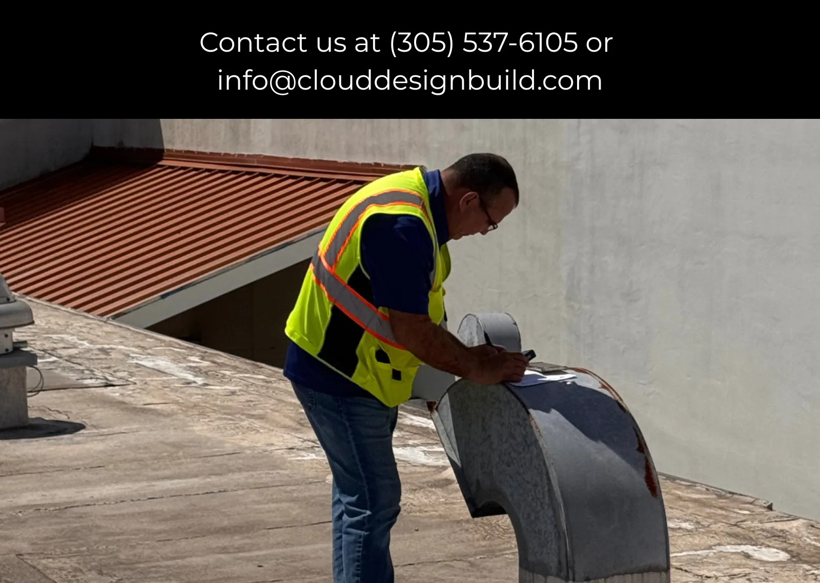 Consultant in a safety vest inspecting rooftop vent equipment