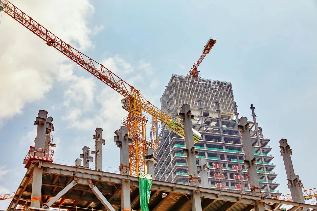 Tower crane beside a high-rise building under construction